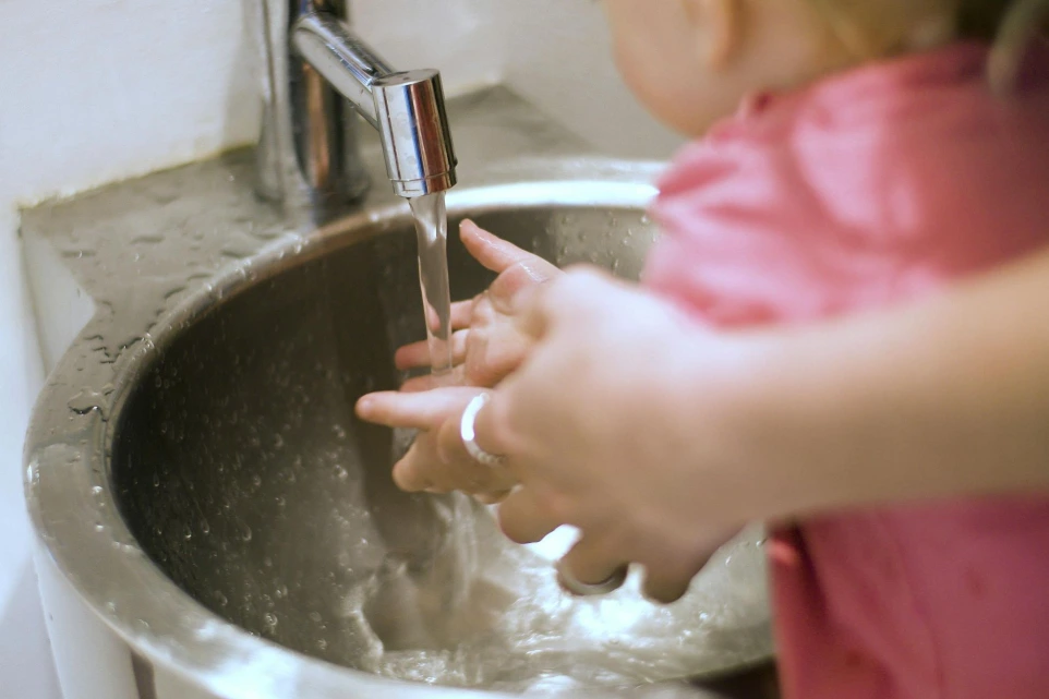 child at the sink